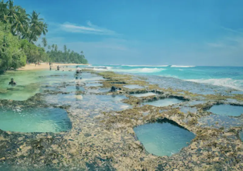 beach with strange holes, crystal water and beach with sand and palm trees